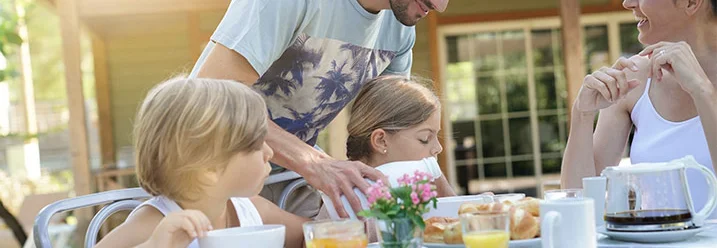 Familie frühstückt auf der Terrasse