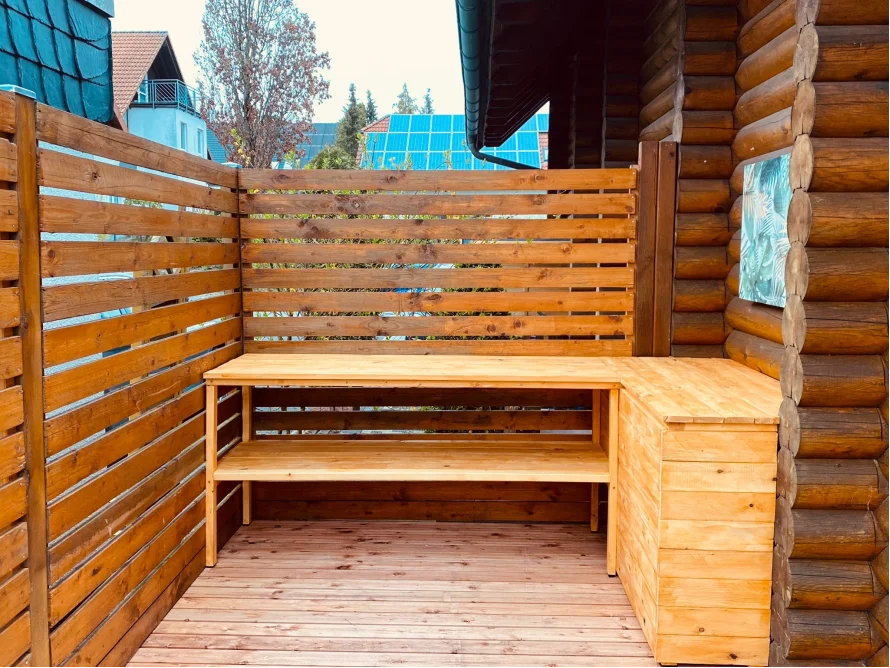 Holztisch an Außenwand