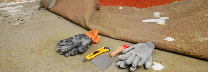 Werkzeug liegt vor halb abgerissenem Teppich