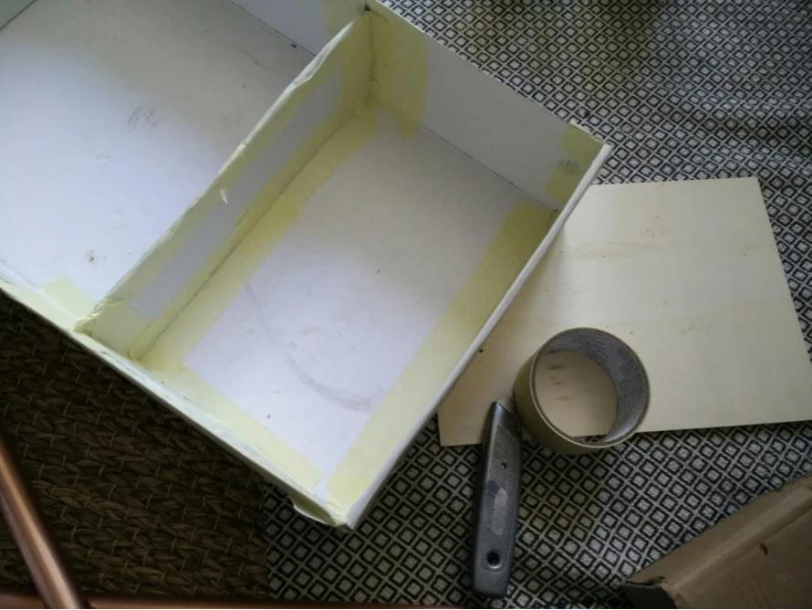Eine weiße Schachtel mit Klebeband ausgelegt.