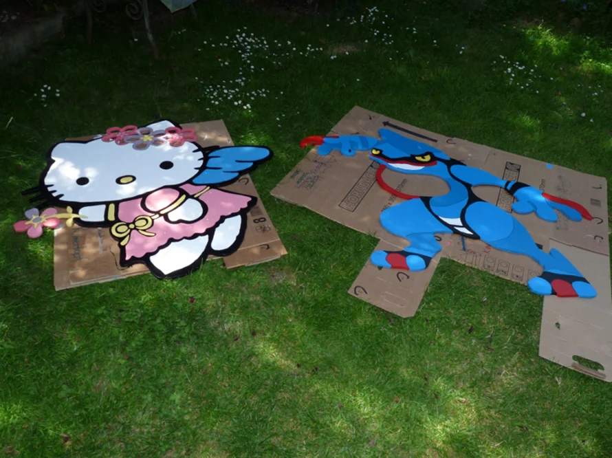 Zwei Comicfiguren aus Holz auf dem Rasen