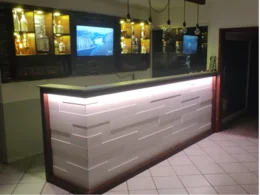 Weißer Tresen mit Bar im Hintergrund